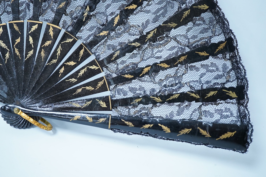 A collection of 19th century and later fans to include a black lacquered and lace example and a hand painted floral example